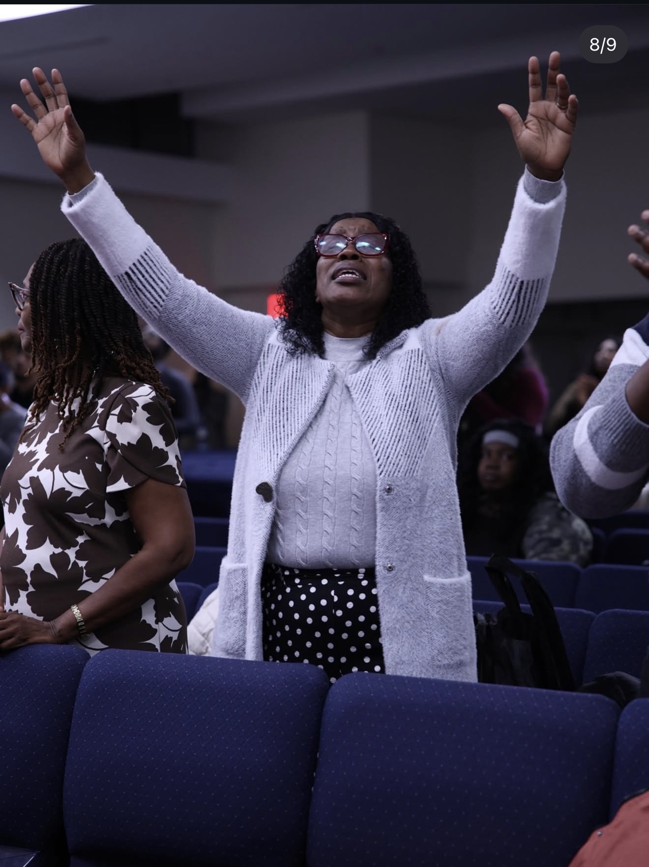 Rehoboth Open Bible Church member praying with hands raised